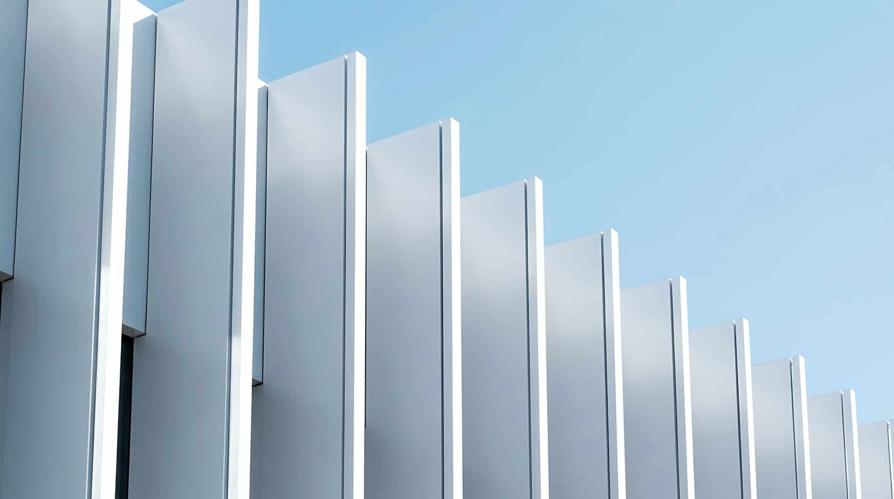 Modern metal building facade against blue sky